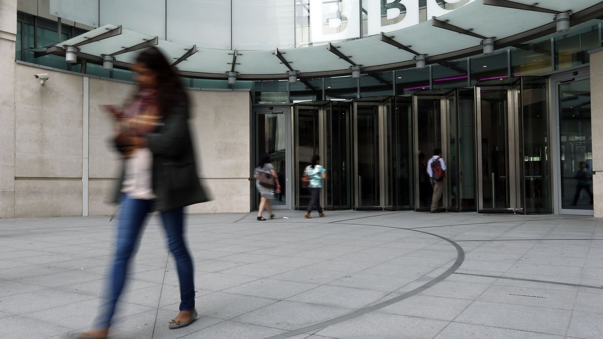 Employees arrive at Broadcasting House, London