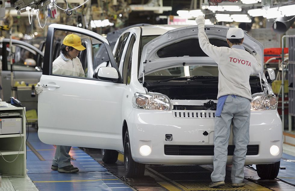 Employees of Toyota Motor Corporation work during the assembly process at the company's Takaoka Plant