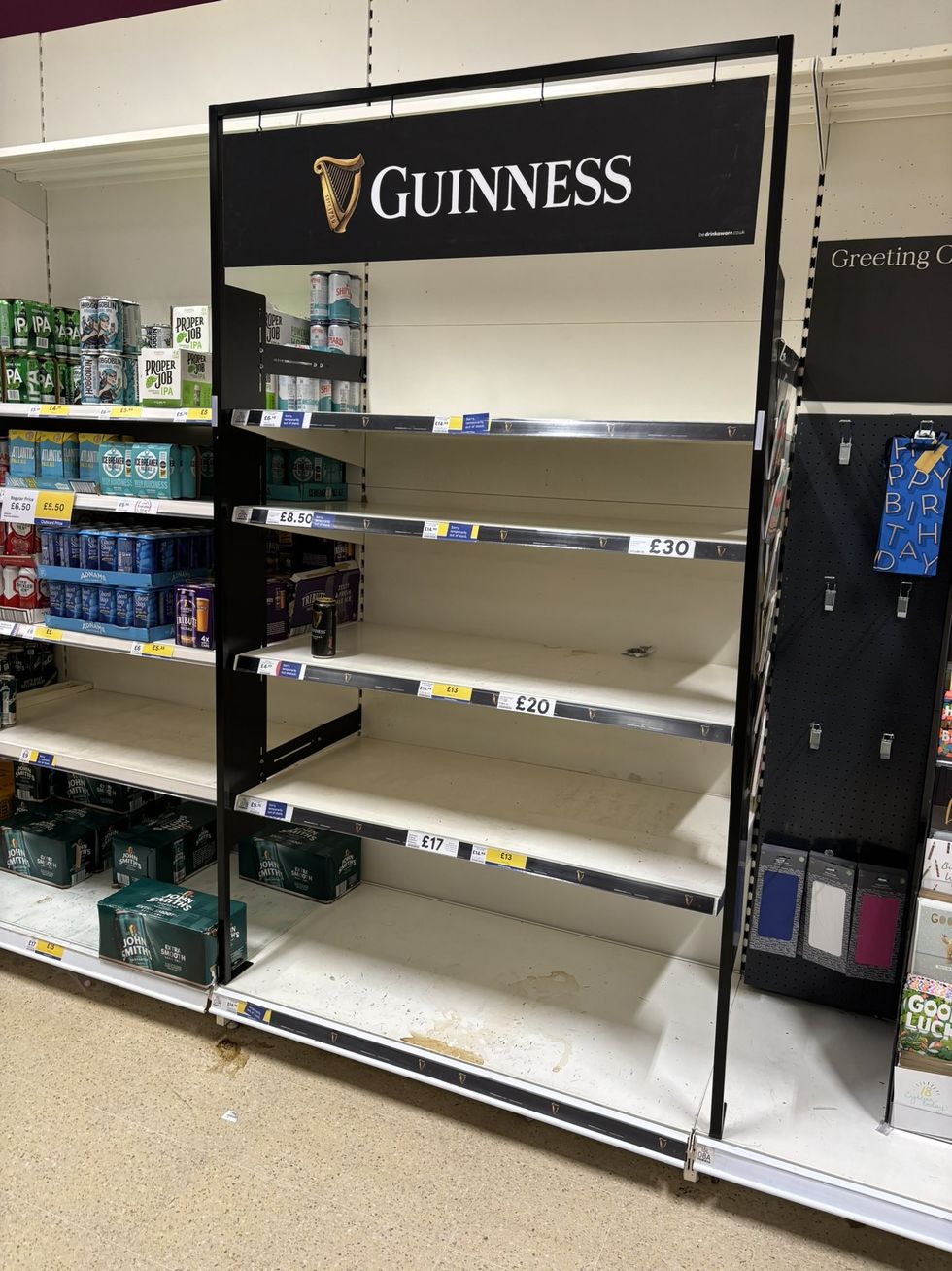Empty Tesco shelves Guinness