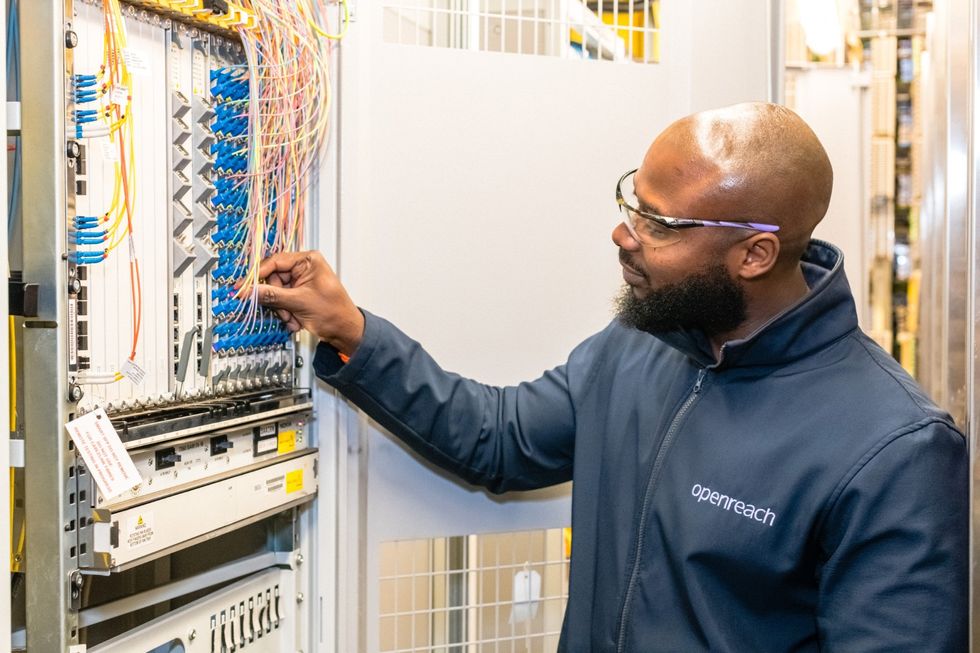 engineer checks cables to connect broadband