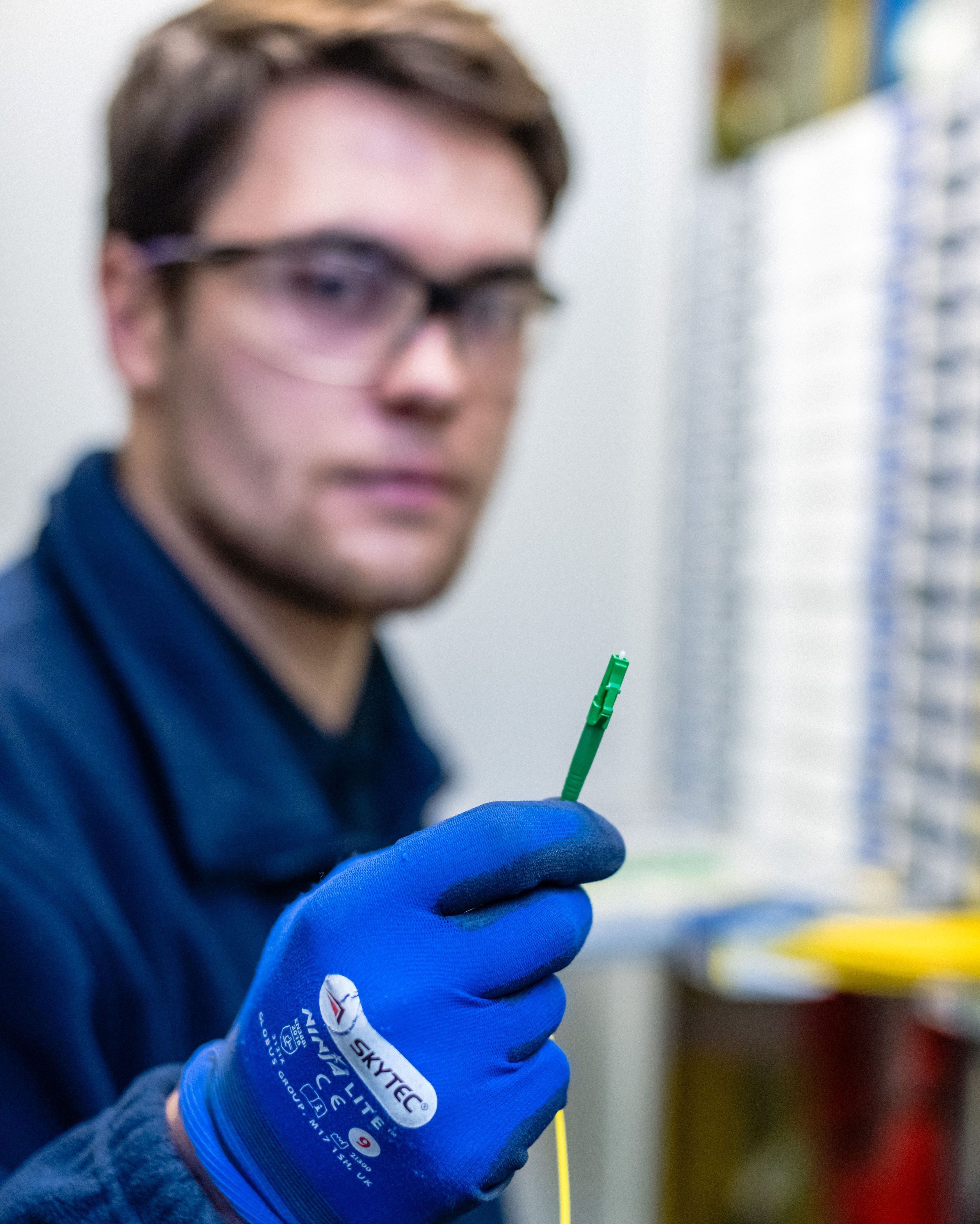 engineer holds the fibre-optic cable used in the broadband trial