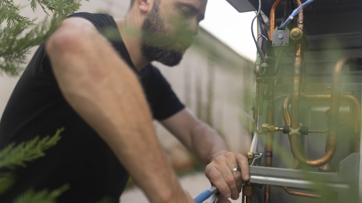 Engineer installing heat pump