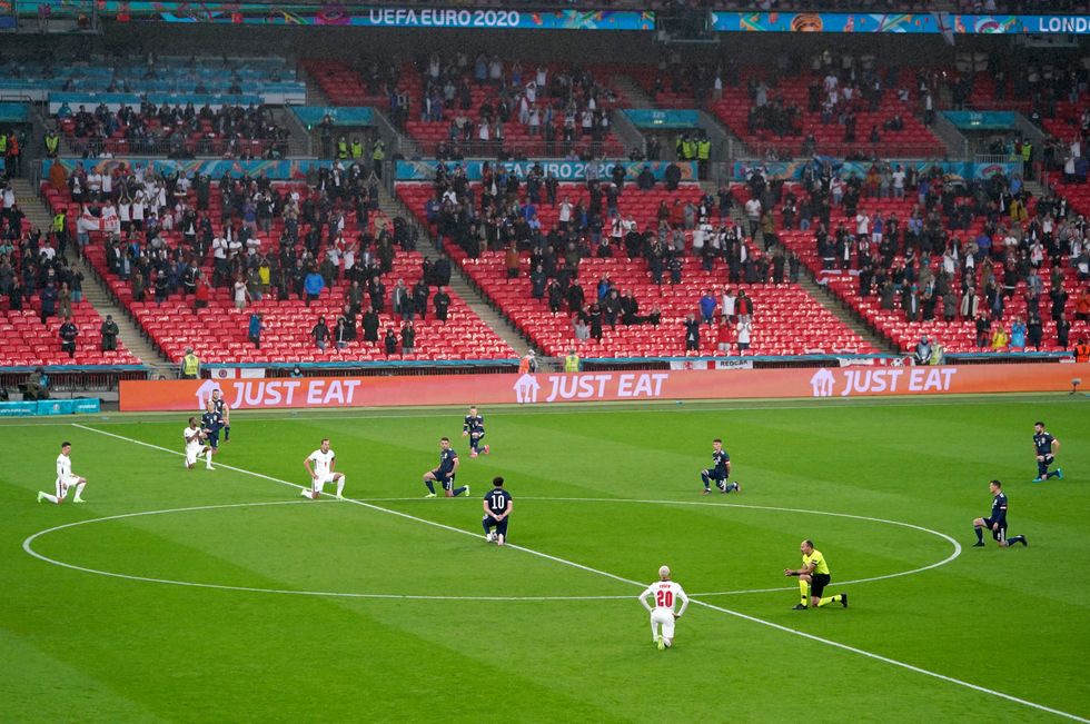 England and Scotland players take a knee ahead of the Euro 2020 match at Wembley
