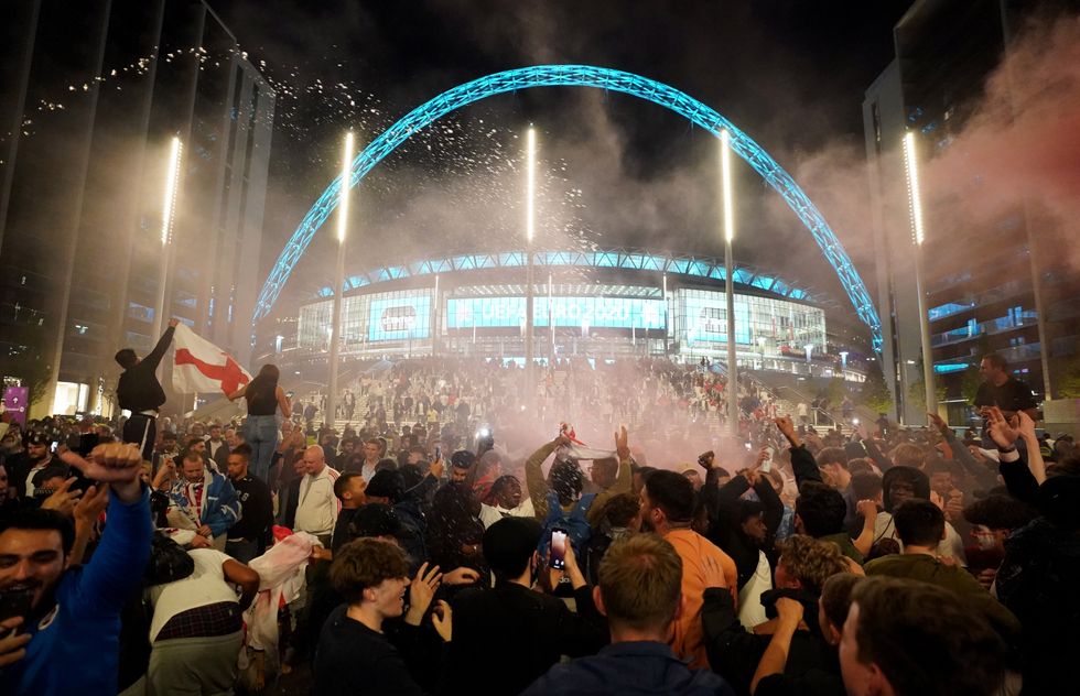 England fans celebrate outside Wembley Stadium after England qualified for the Euro 2020 final where they will face Italy on Sunday 11th July, following the UEFA Euro 2020 semi final match between England and Denmark. Picture date: Wednesday July 7, 2021.
