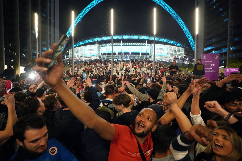 England fans celebrate outside Wembley Stadium after England qualified for the Euro 2020 final where they will face Italy on Sunday 11th July, following the UEFA Euro 2020 semi final match between England and Denmark. Picture date: Wednesday July 7, 2021.