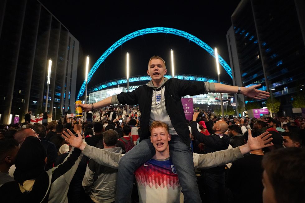 England fans celebrate outside Wembley Stadium after England qualified for the Euro 2020 final where they will face Italy on Sunday 11th July, following the UEFA Euro 2020 semi final match between England and Denmark. Picture date: Wednesday July 7, 2021.