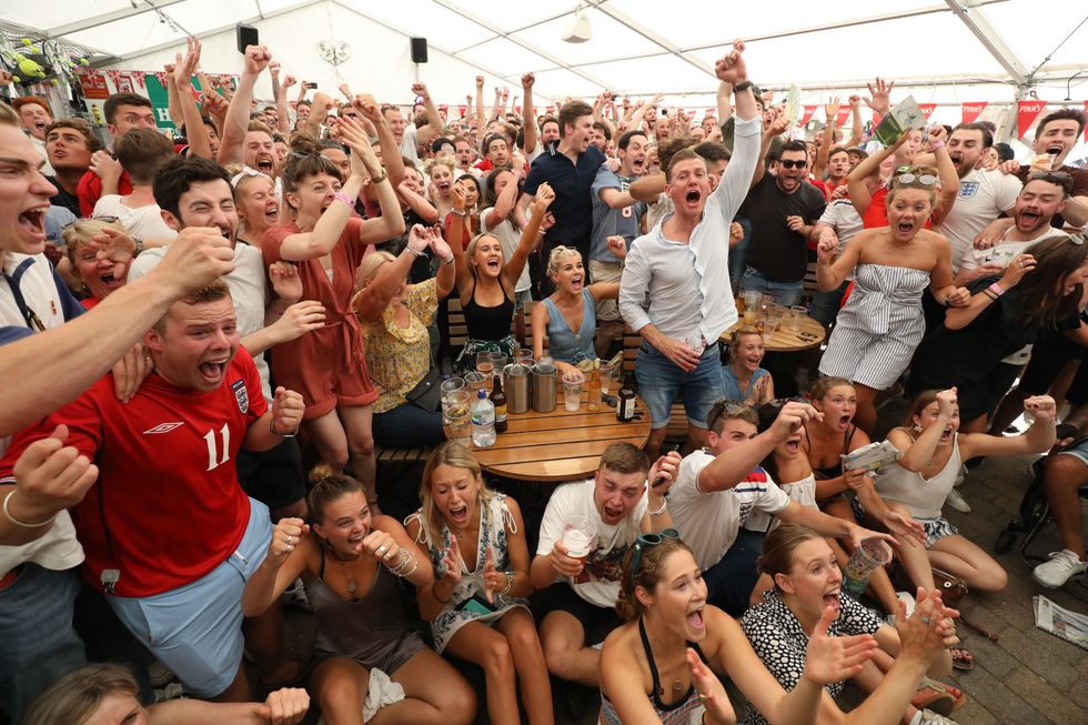 England fans celebrate the first goal from Harry Maguire in the FIFA World Cup 2018 quarter-final match between Sweden and England at the Rose & Crown pub, in Wimbledon, south London.