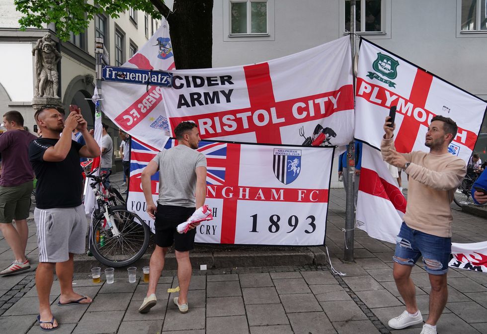 England football fans erect flags in Frauenplatz square in Munich, there is no suggestion any of these fans were involved