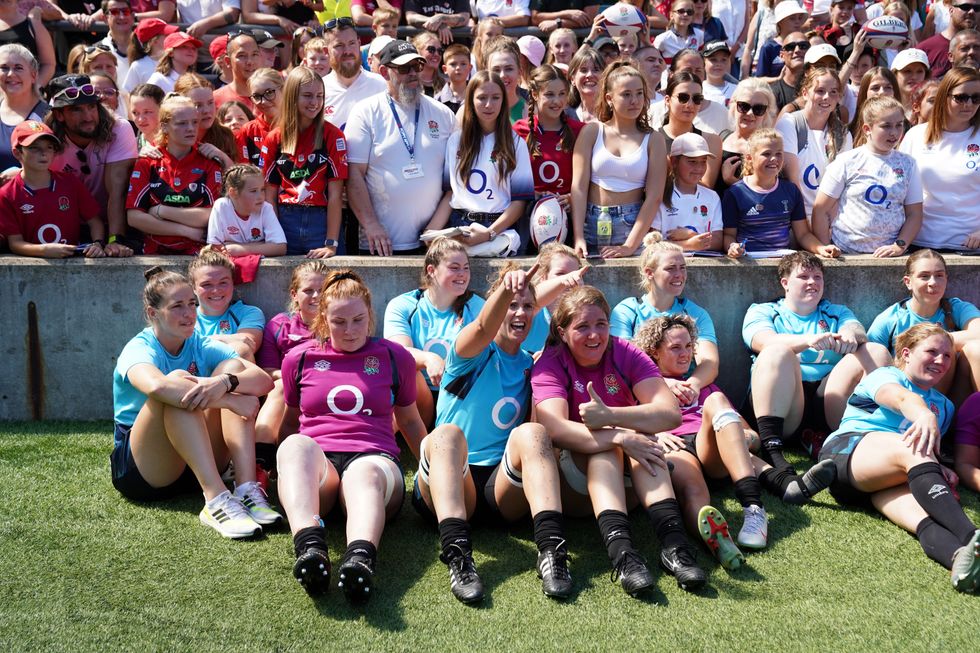 England players poses for a photograph with fans after an open training session at Twickenham Stadium, London. Picture date: Thursday August 11, 2022.