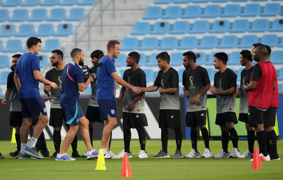 England's Harry Kane shakes hands with the Workers' Welfare 'Team 360' players during a Community Engagement event at the Al Wakrah Sports Club Stadium in Al Wakrah, Qatar. Picture date: Thursday November 17, 2022.
