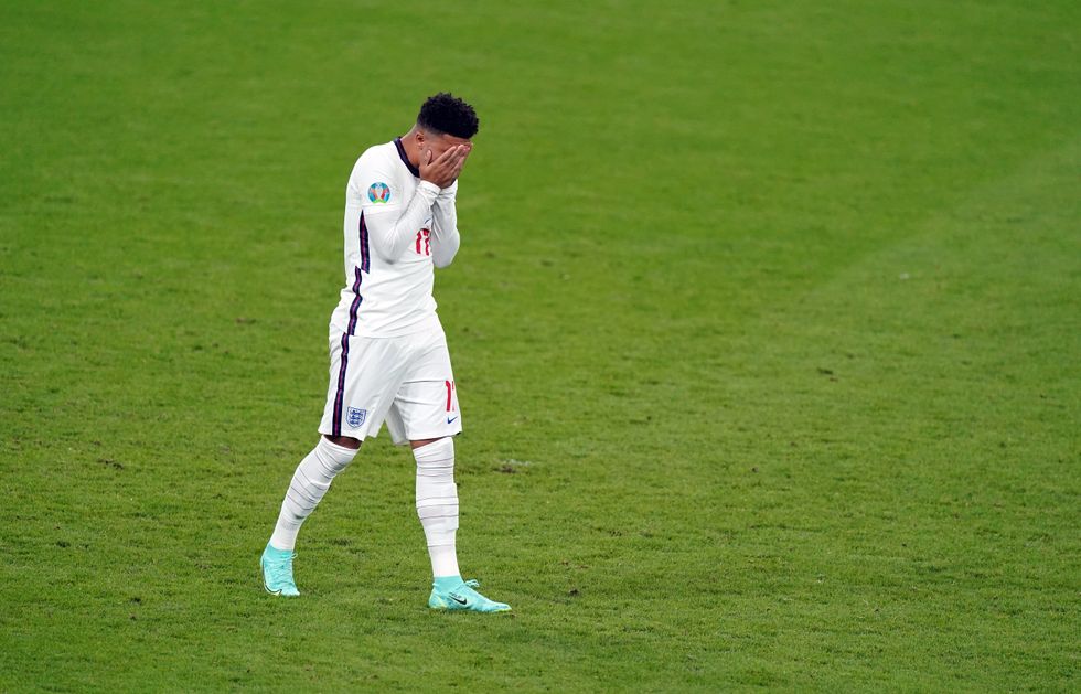 England's Jadon Sancho stands dejected after missing from the penalty spot against Italy in the final of Euro 2020.