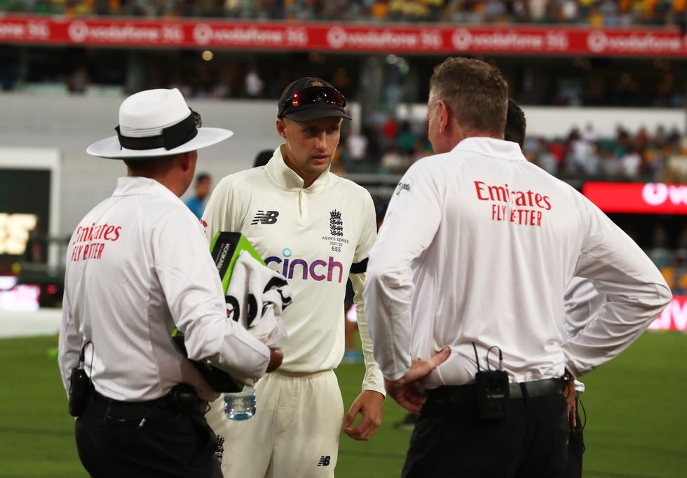 England's Joe Root talks to the umpires during day one of the first Ashes test at The Gabba, Brisbane.