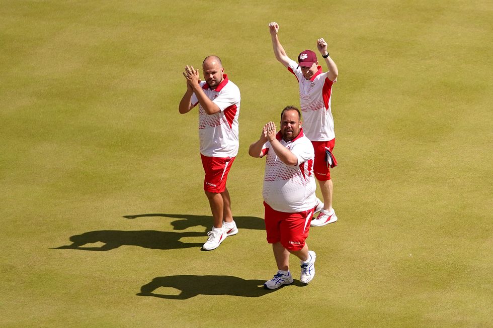 England's Nick Brett, Louis Ridout and Jamie Chestney celebrate winning gold following the Men's Triples - Gold Medal Match at Victoria Park
