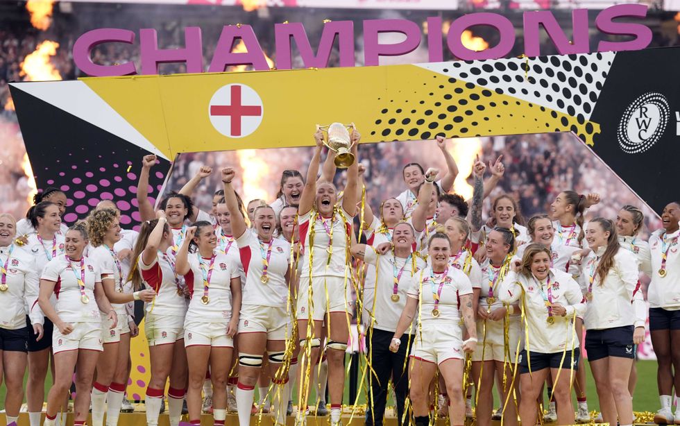 England's players celebrate as Zoe Aldcroft lifts the Women's Rugby World trophy