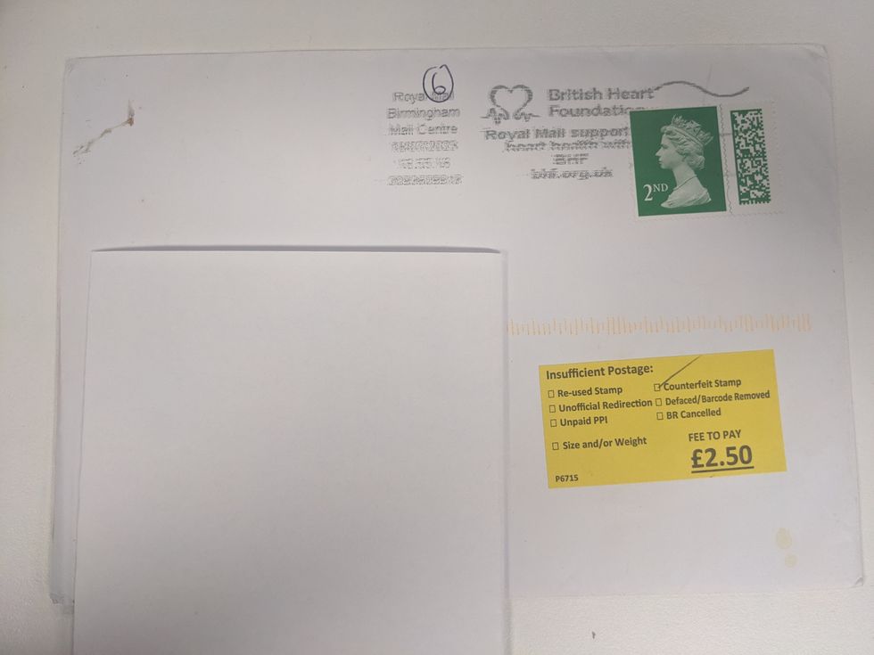 Envelope showing Royal Mail has deemed the second class stamp as "counterfeit" and charged \u00a32.50