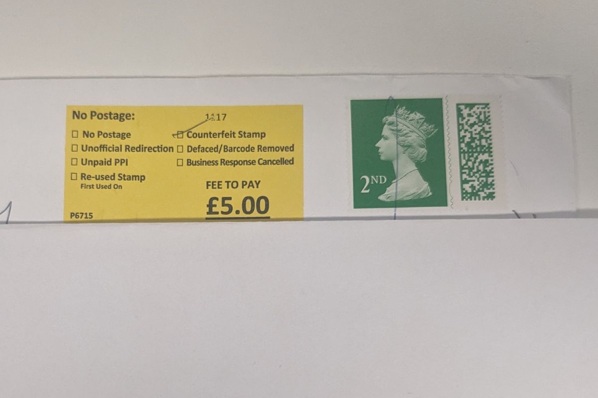 Envelope shows Royal Mail deemed second-class stamp as "counterfeit" and applied a \u00a35 surcharge