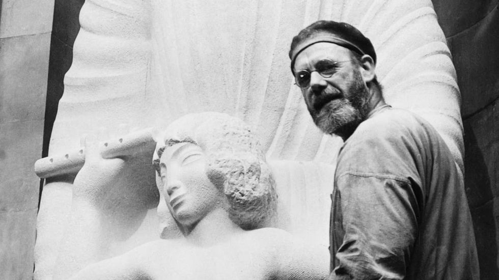 Eric Gill with Ariel and Prospero statue