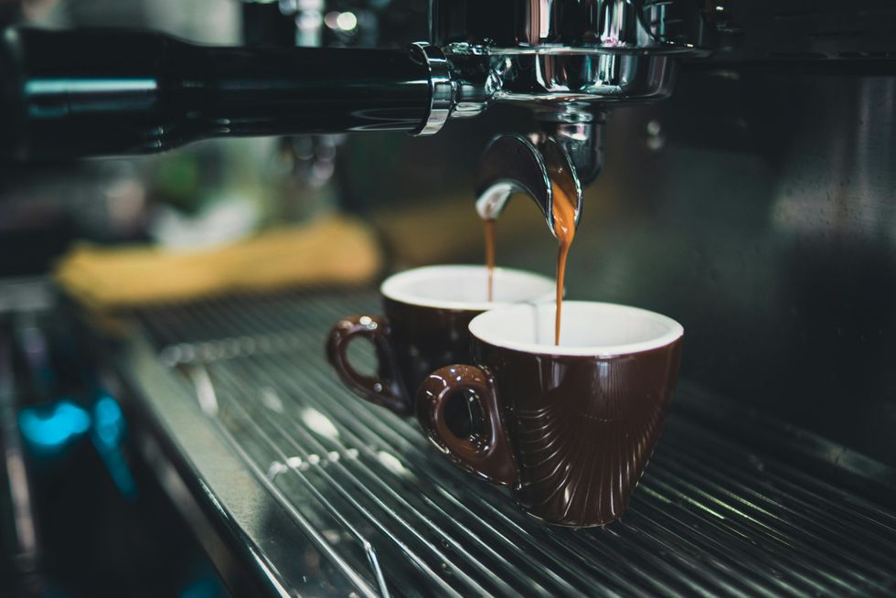 Espresso brewing into two cups