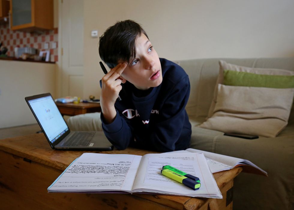 Euan Stanton, a year 7 pupil at a secondary school in Ashford, Kent, studies at home as many schools switch to online learning following their closure due to the increasing spread of Covid-19.
