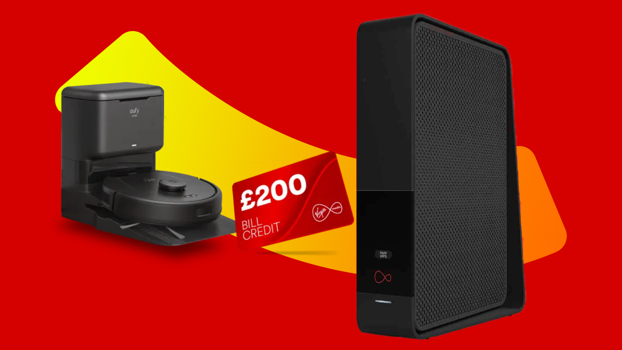 eufy robot vacuum cleaner pictured in charging stand with a credit card for £200 bill credit pictured beside the virgin media router