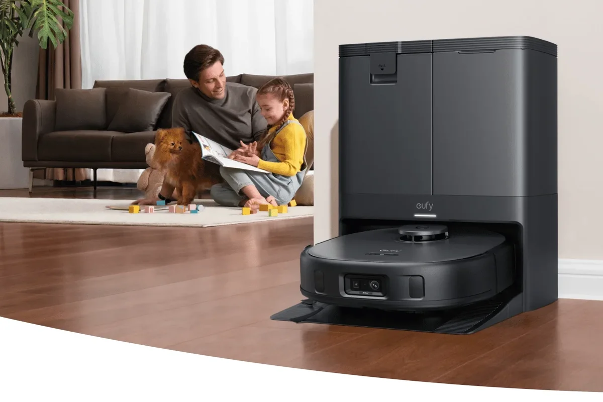 eufy vacuum cleaner in its charging station by a skirting board