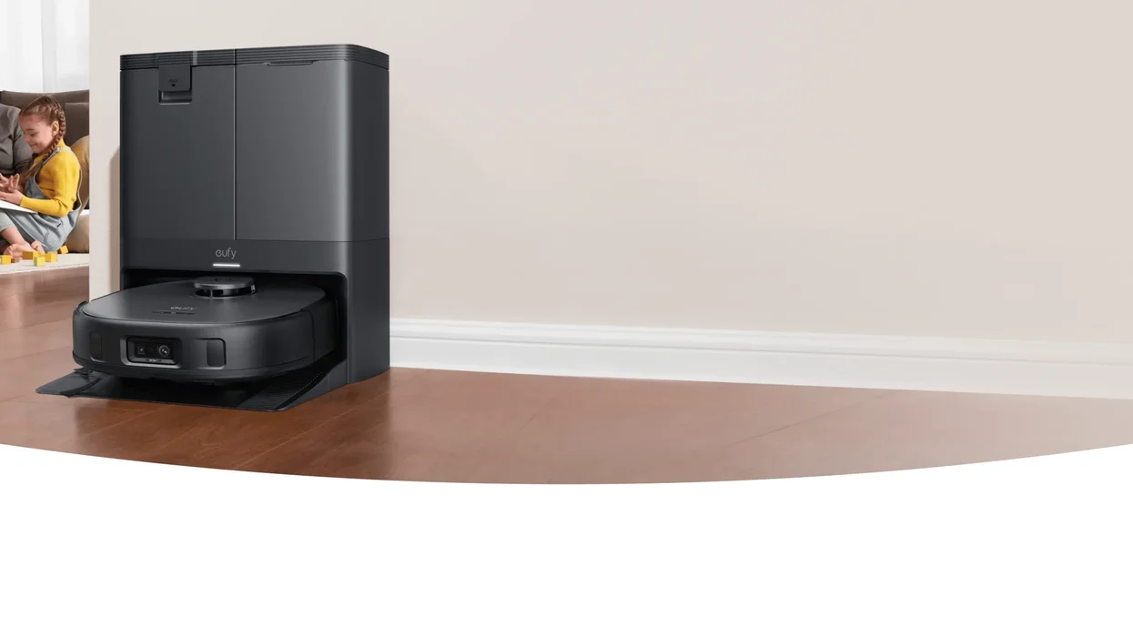 eufy vacuum cleaner in its charging station by a skirting board