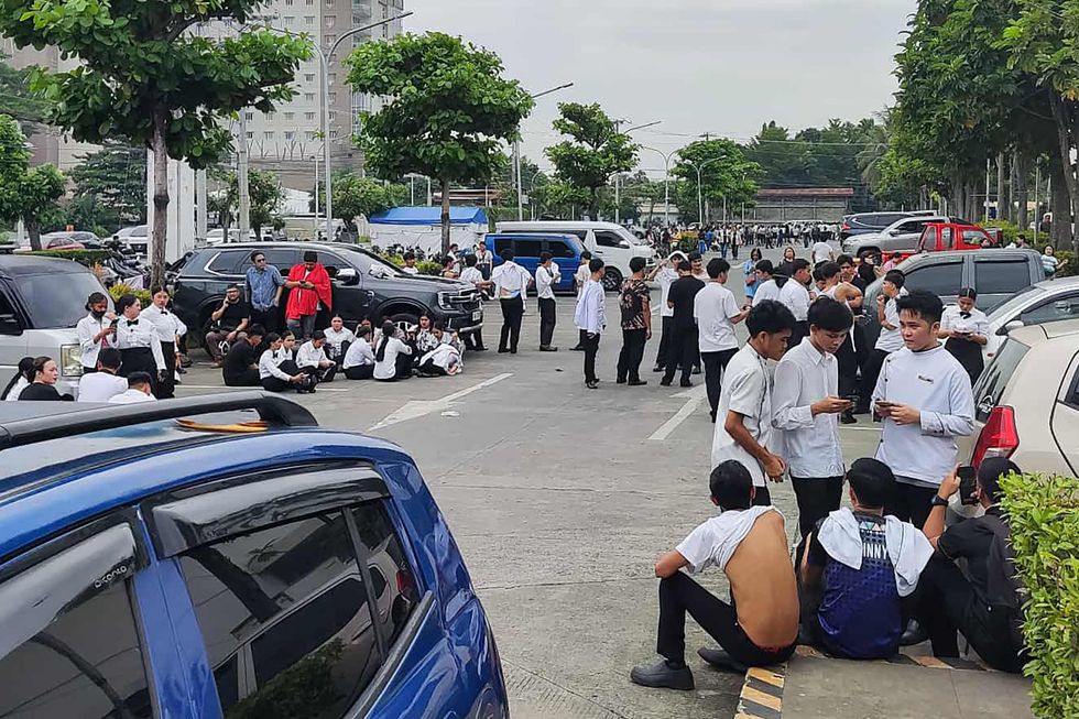 Evacuated employees gathering outside a shopping centre in Davao City, on the southern island of Mindanao
