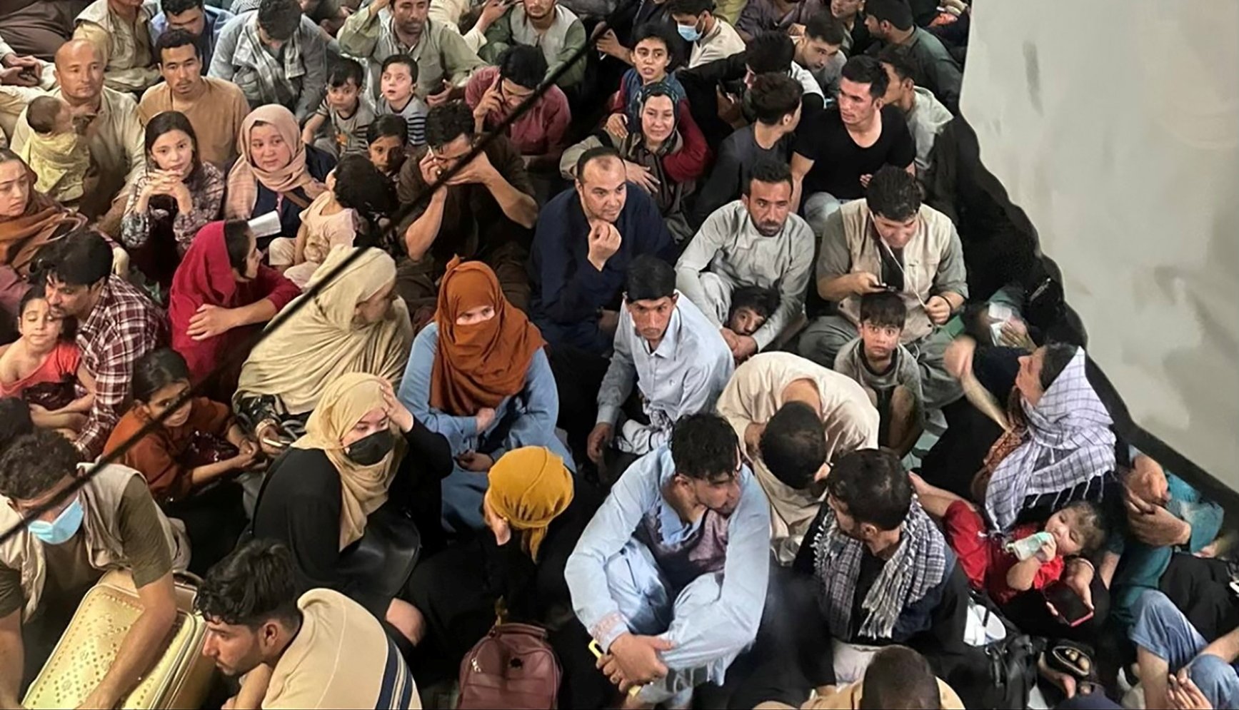 Evacuees crowd the interior of a U.S. Air Force C-17 Globemaster III transport aircraft, carrying some 640 Afghans to Qatar from Kabul, Afghanistan August 15, 2021. Picture taken August 15, 2021.