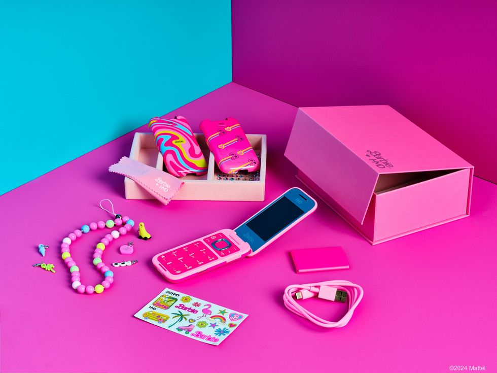 everything included in the barbie phone box including two alternative rear panels a lanyard stickers and a charging cable