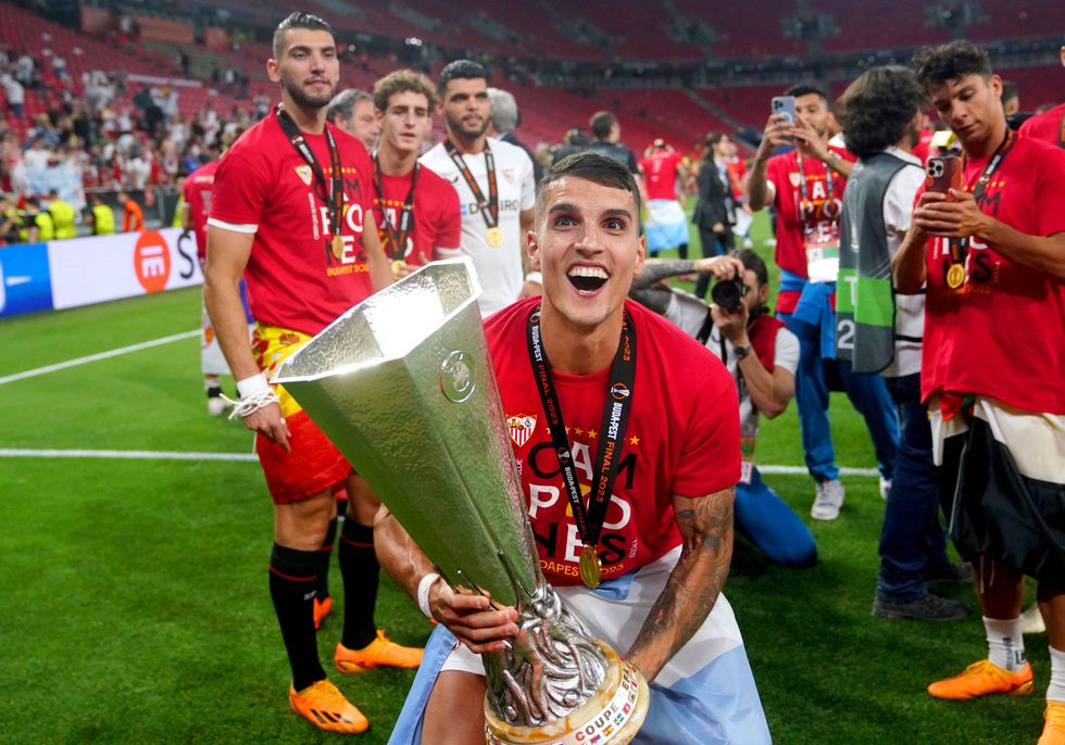 Ex-Spurs player Erik Lamela lifting the Europa League trophy