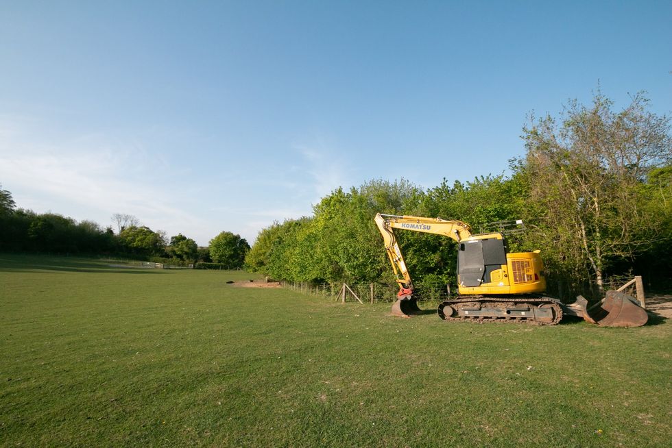 Excavator in a field