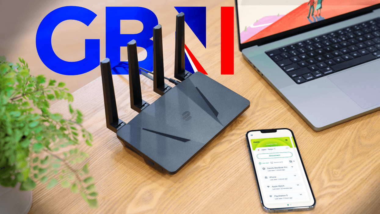 ExpressVPN Wi-Fi router pictured on a desk next to a laptop and iPhone running the app