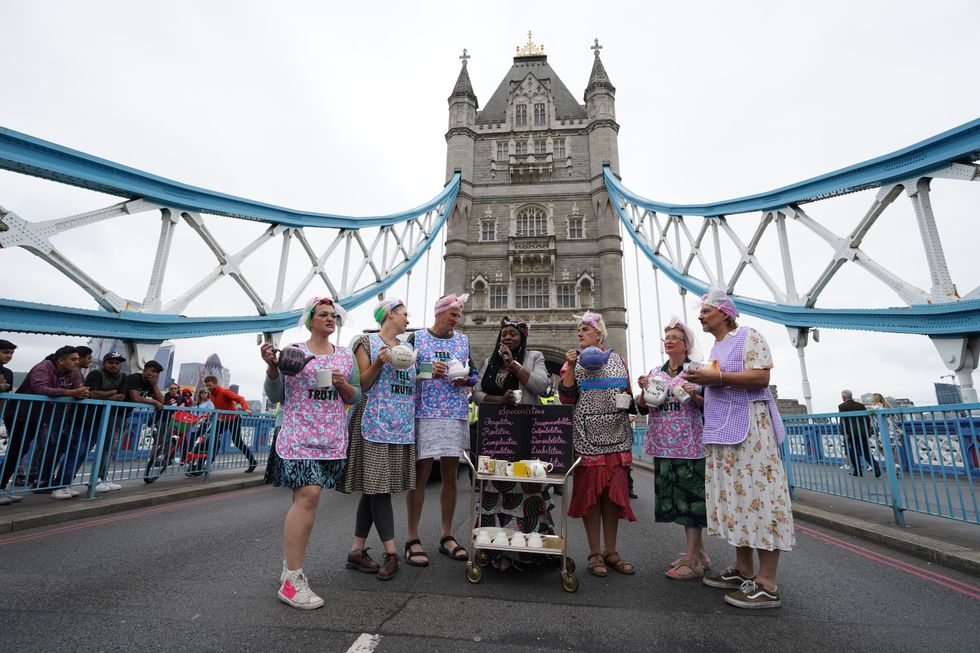 Extinction Rebellion members on Tower Bridge, central London, which has been blocked by a caravan. Picture date: Monday August 30, 2021.