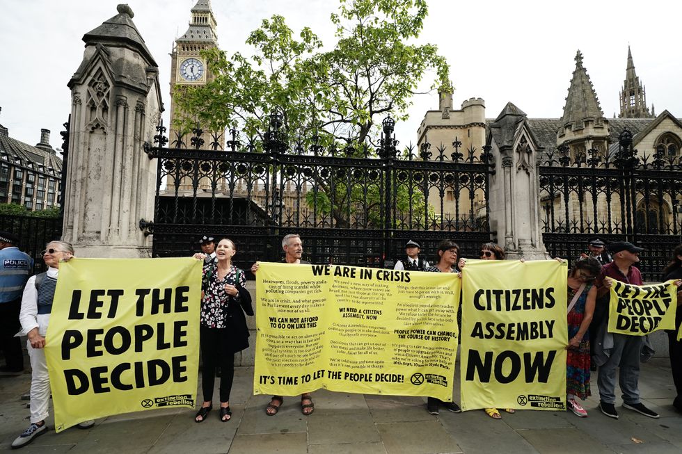 Extinction Rebellion protesters outside the Houses of Parliament, Westminster, calling for a Citizen's assembly. The campaign group says supporters have also superglued themselves around the Speaker's chair in the House of Commons chamber. Picture date: Friday September 2, 2022.