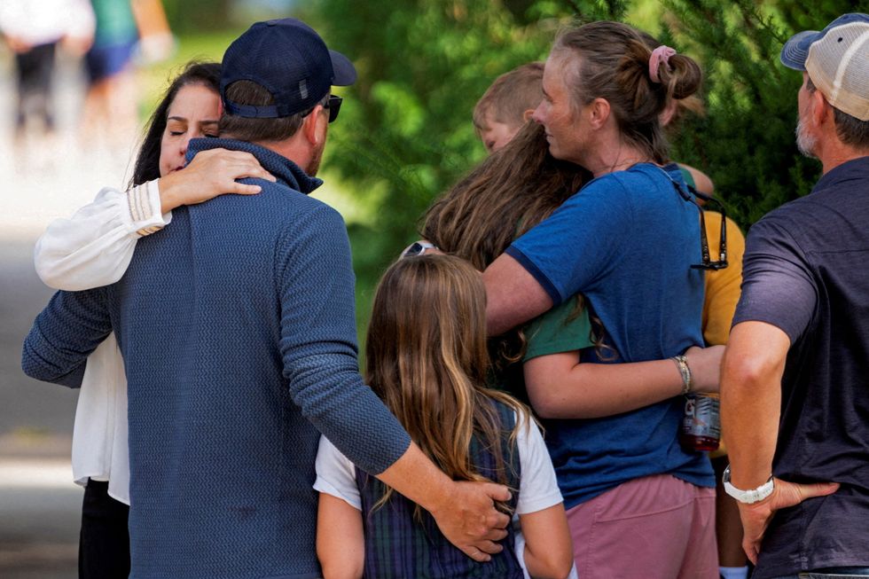 Families and loved ones reunite outside the police barricades after a shooting at Annunciation Church\u200b