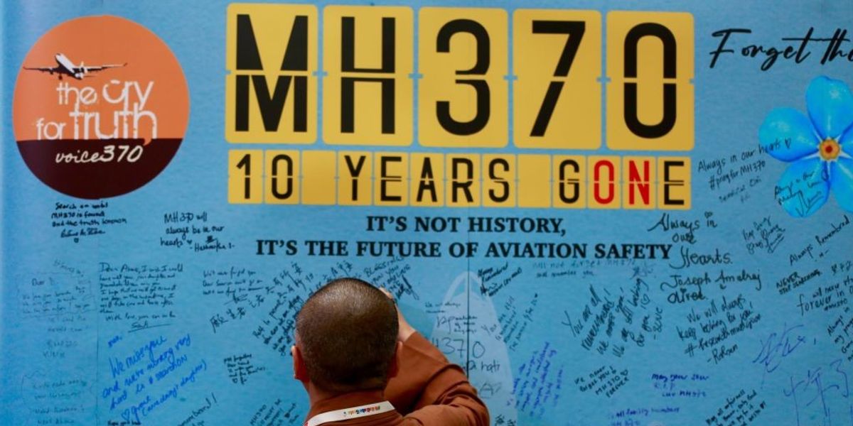 NextImg:Families write on the memorial wall for victims of MH370