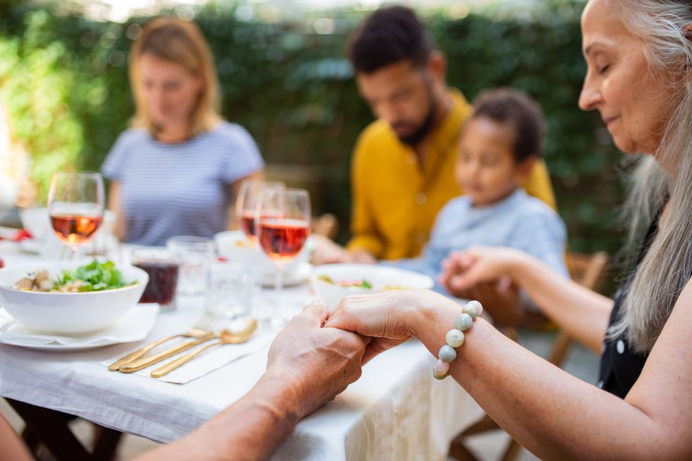 Family praying before eating