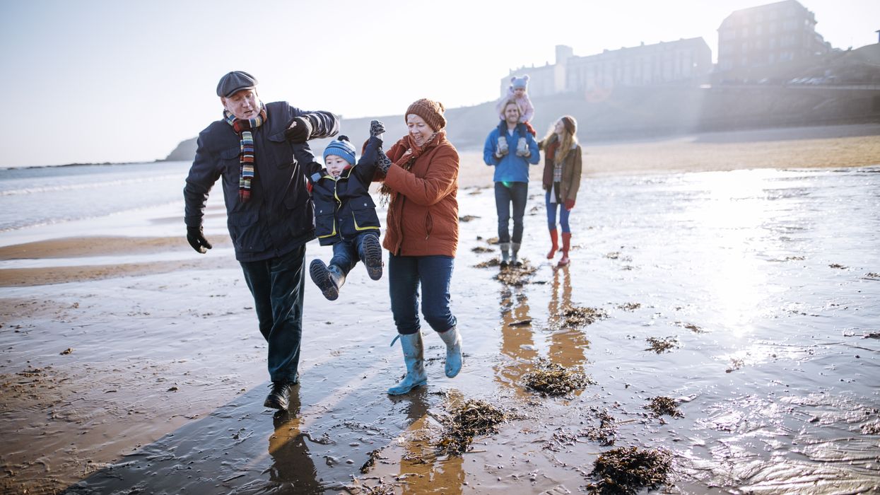 Family walking down the coastline