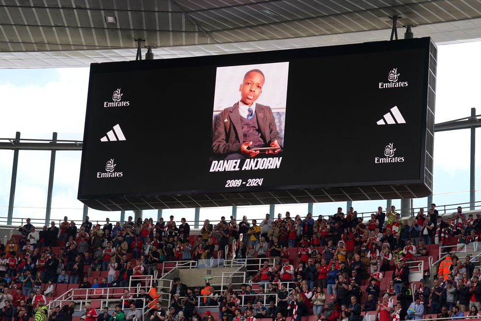 Fans applaud in memory of 14-year-old Daniel Anjorin, who died following the sword attack in east London