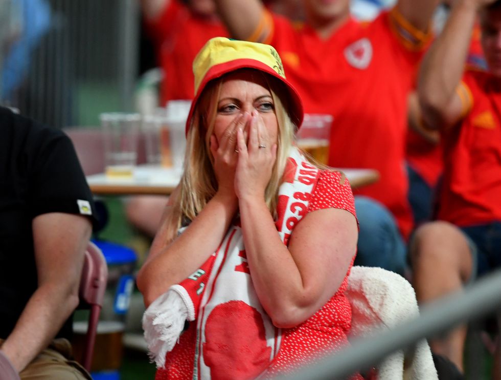 Fans at Vale Sports Park in Cardiff watch the UEFA Euro 2020 round of 16 match between Wales and Denmark.