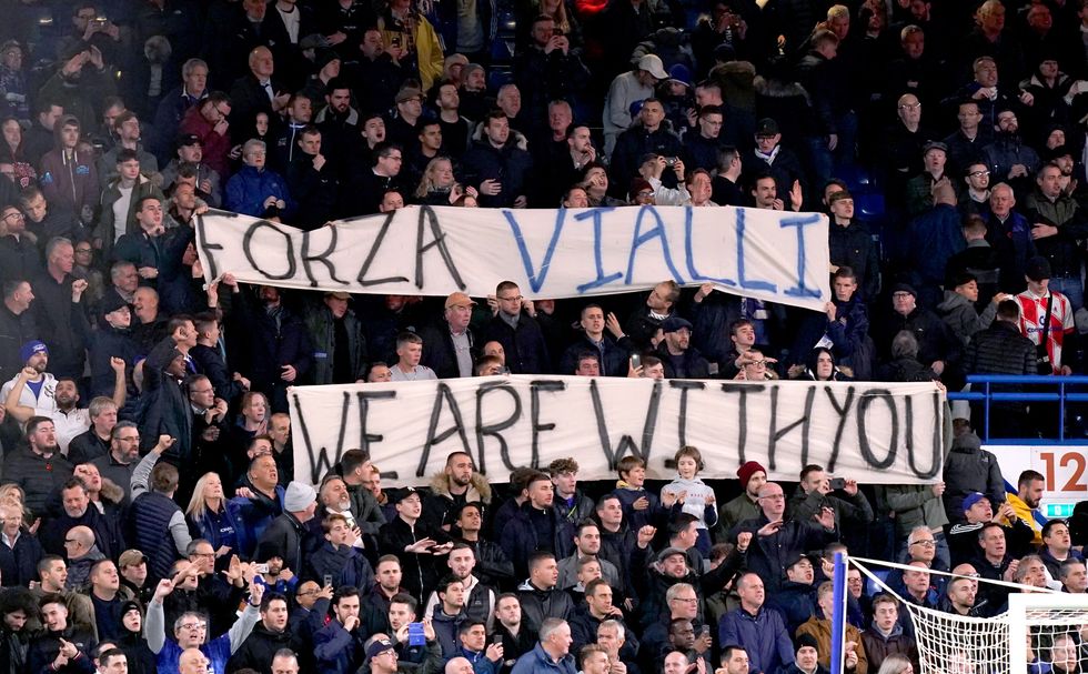 Fans in the stands hold up banners for former Chelsea manager Gianluca Vialli prior to the beginning of the Carabao Cup, Fourth Round match at Stamford Bridge, London.