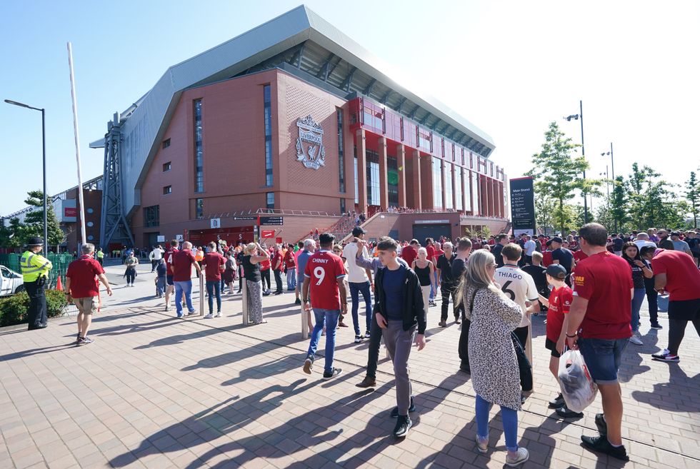 Fans make their way to the ground ahead of the Premier League match at Anfield, Liverpool.