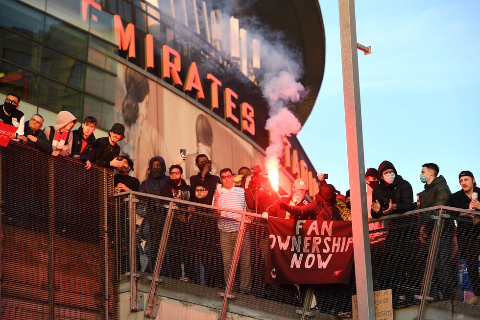 Fans protest against Arsenal owner Stan Kroenke before the Premier League match at the Emirates Stadium, London. Picture date: Friday April 23, 2021.