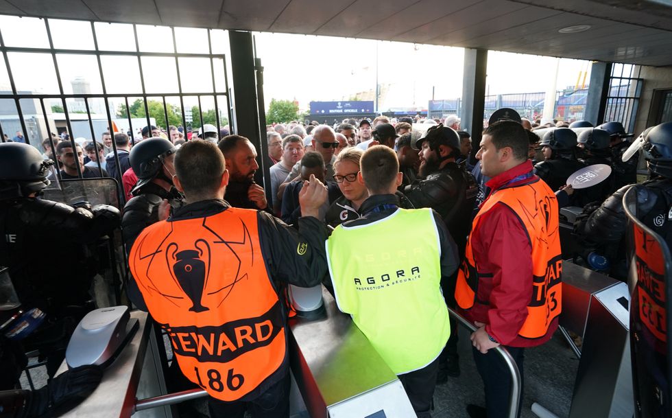 Fans waiting outside the gates to enter the stadium as kick off is delayed before the UEFA Champions League Final at the Stade de France, Paris. Picture date: Saturday May 28, 2022.