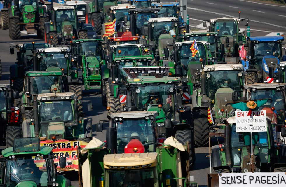 Farmers use their tractors to block the C-33 highway as they drive to Barcelona