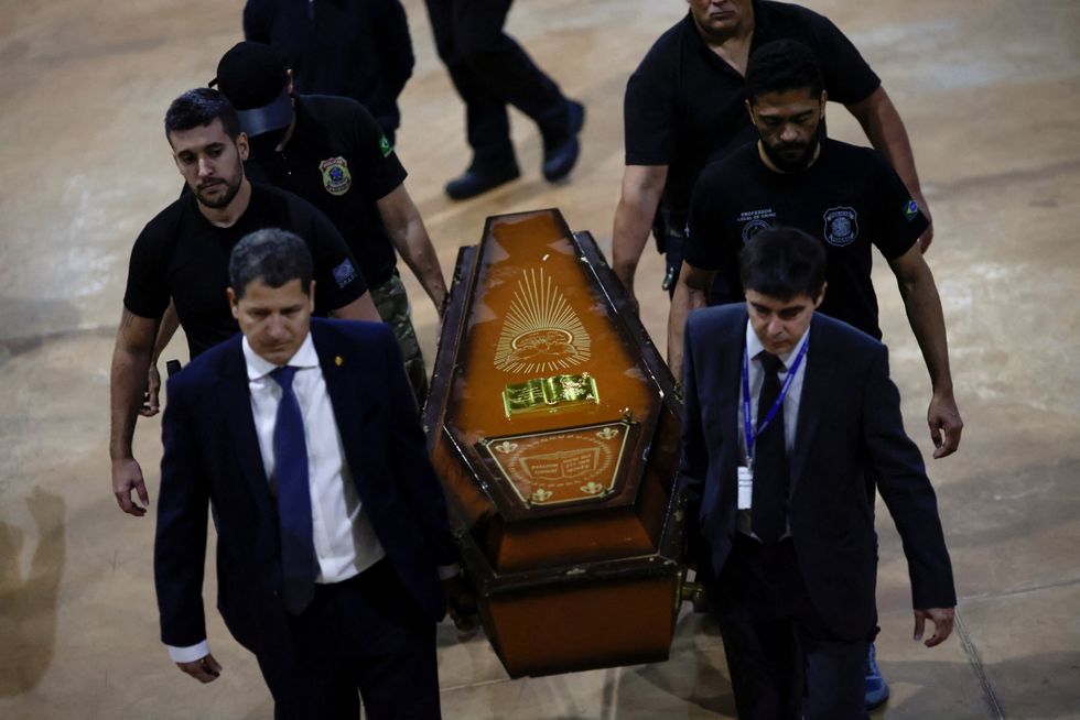 Federal Police officers carry a coffin containing human remains after a suspect confessed to killing British journalist Dom Phillips and Brazilian indigenous expert Bruno Pereira and led police to the location of remains, at the headquarters of the Federal Police, in Brasilia, Brazil