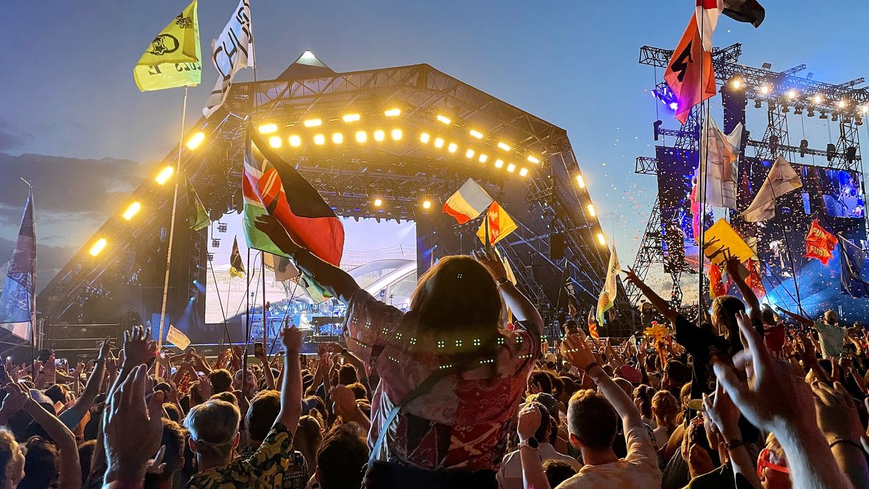 festival goers celebrate outside of the Pyramid Stage at Glastonbury