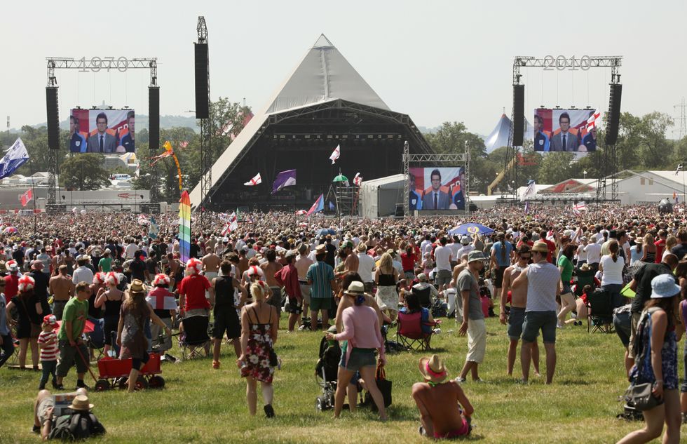 Festival-goers watch England versus Slovenia in the World Cup, which was shown on a screen on the Pyramid Stage at the Glastonbury Festival at Worthy Farm, Somerset.