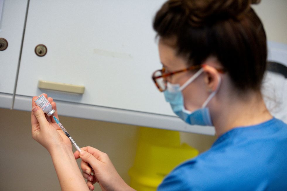 FILE PHOTO: A nurse prepares a dose of the Moderna coronavirus disease (COVID-19) vaccine at the Glangwili General Hospital in Carmarthen, Wales, Britain April 7, 2021. Jacob King/Pool via REUTERS/File Photo