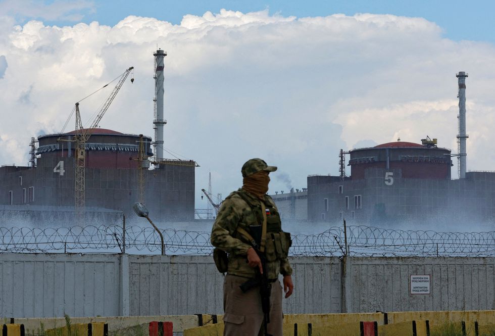FILE PHOTO: A serviceman with a Russian flag on his uniform stands guard near the Zaporizhzhia Nuclear Power Plant in the course of Ukraine-Russia conflict outside the Russian-controlled city of Enerhodar in the Zaporizhzhia region, Ukraine August 4, 2022. REUTERS/Alexander Ermochenko/File Photo